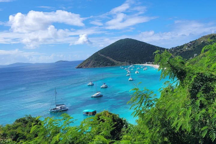 a boat on a body of water with a mountain in the background