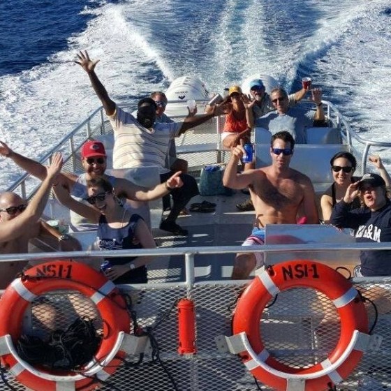 a group of people riding on the back of a boat