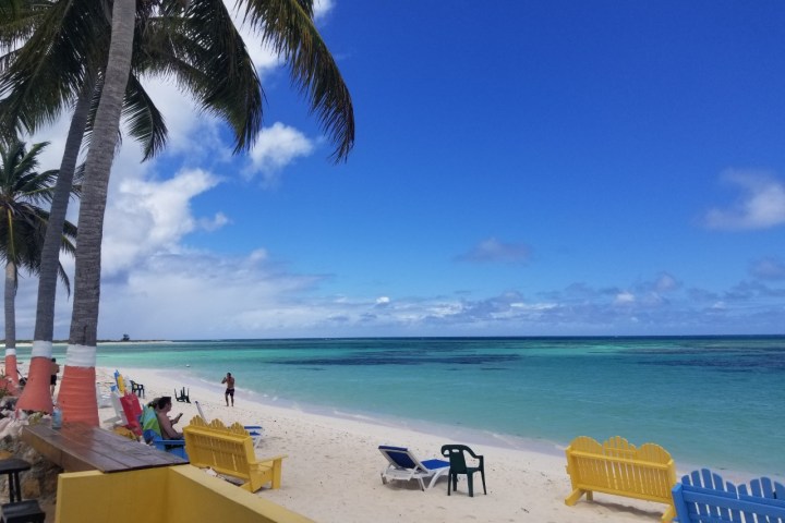 a group of people sitting at a beach